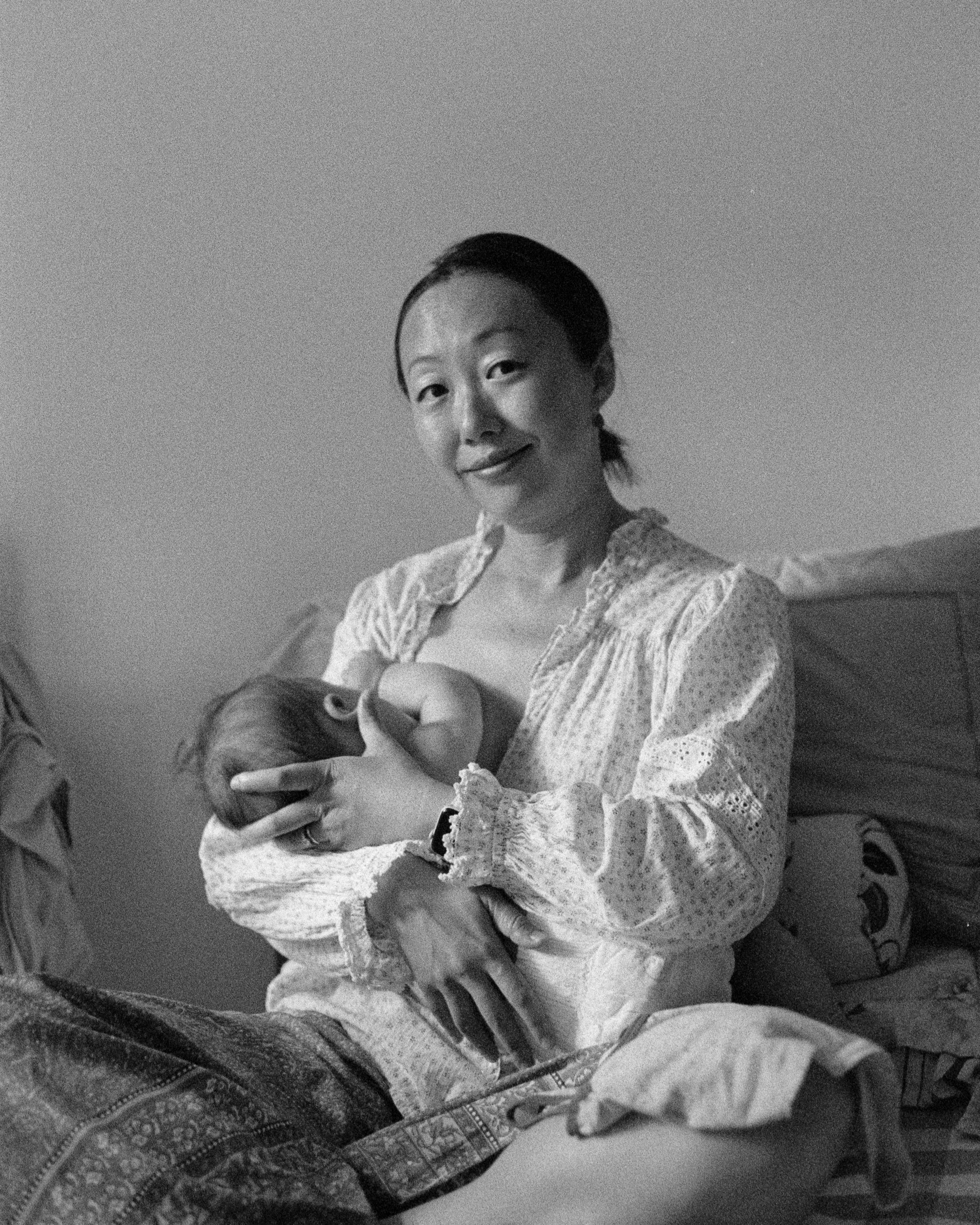 A black and white photo of my wife feeding our son, captured in Beijing on a Pentax MX on Iflord HP5+, developed at home in Ilfosol3 and scanned on a Plustek negative scanner.