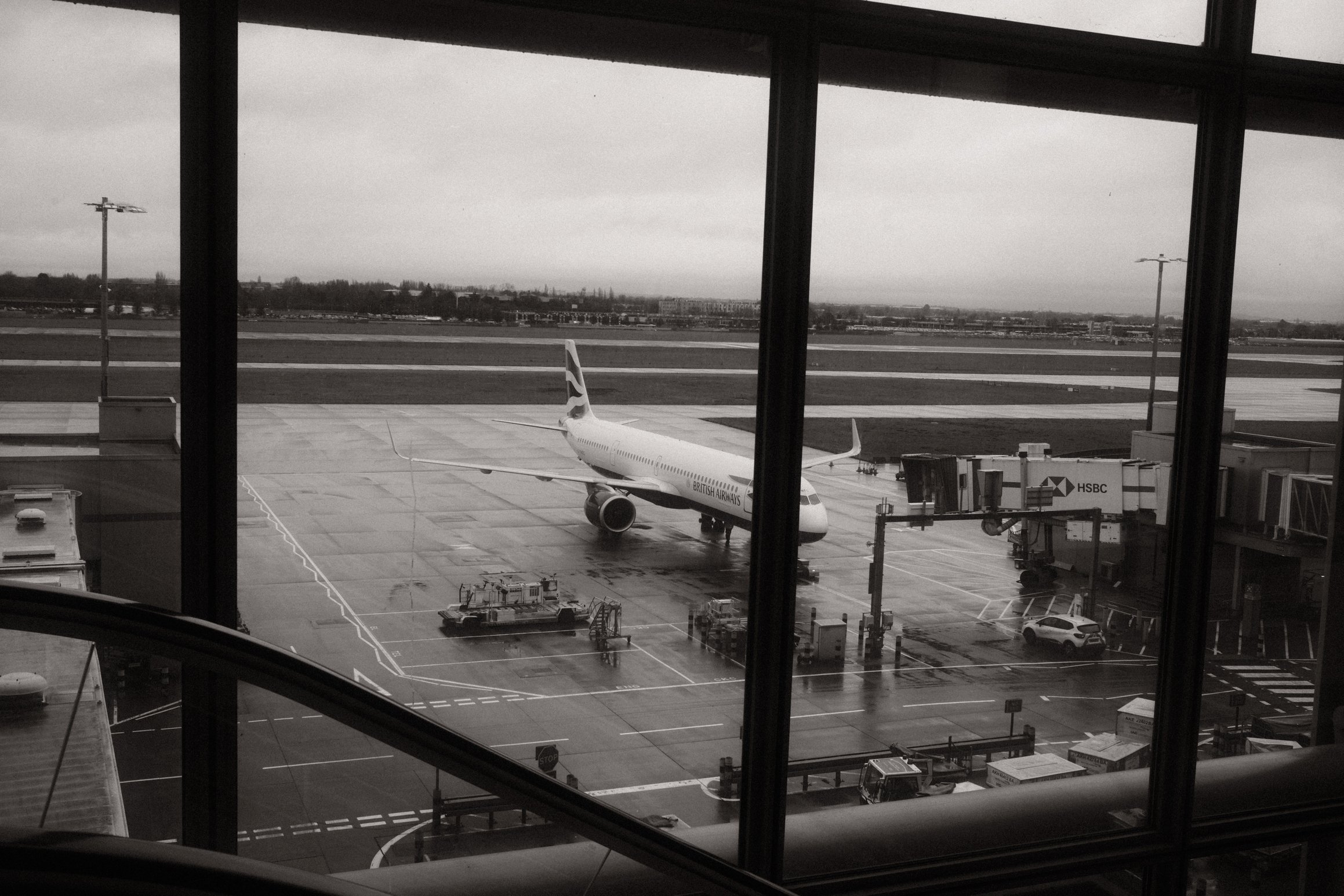 black and white photo of a British Airways plane standing at the gate