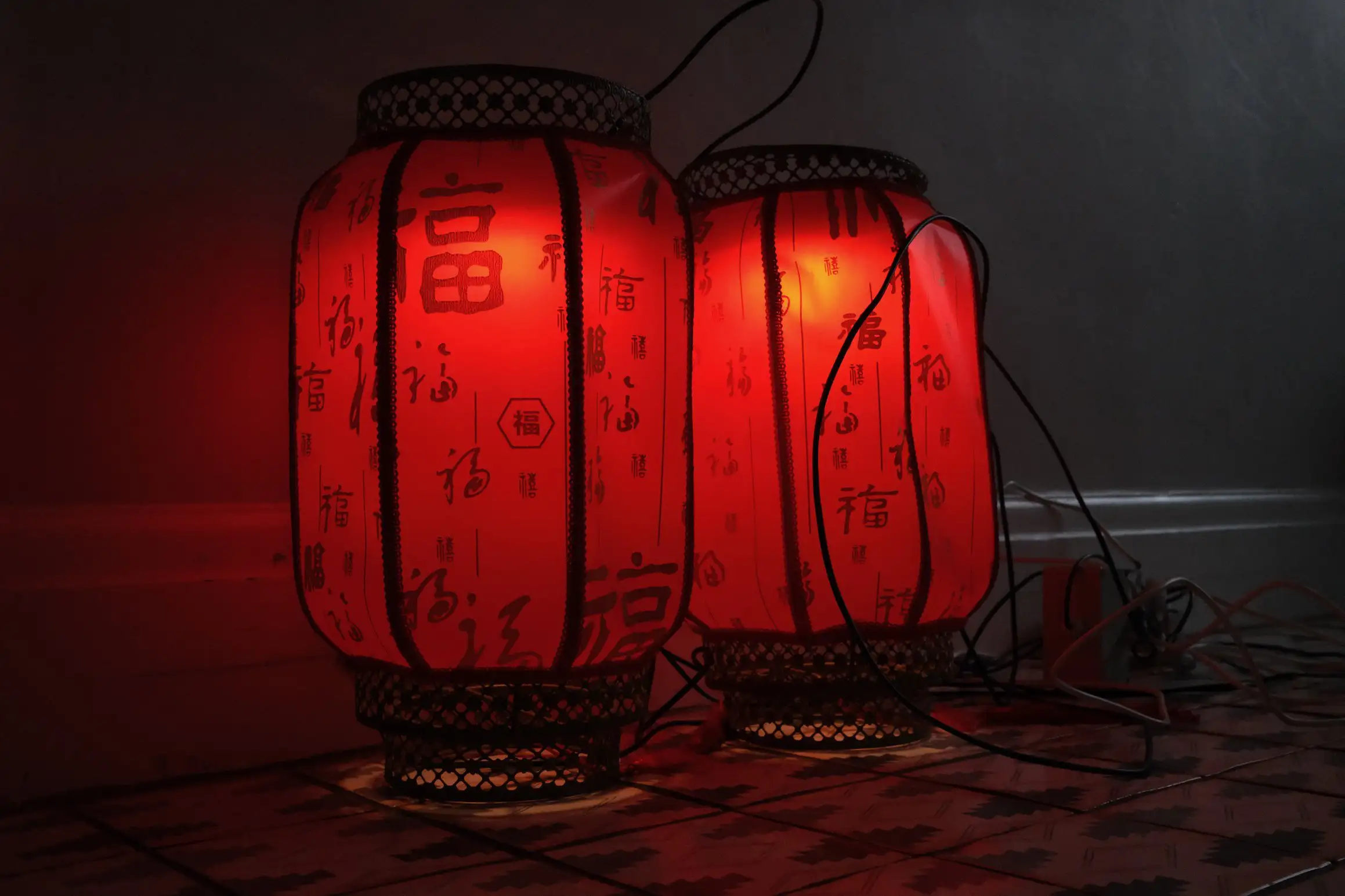 a photo of two red lanterns resting on the floor