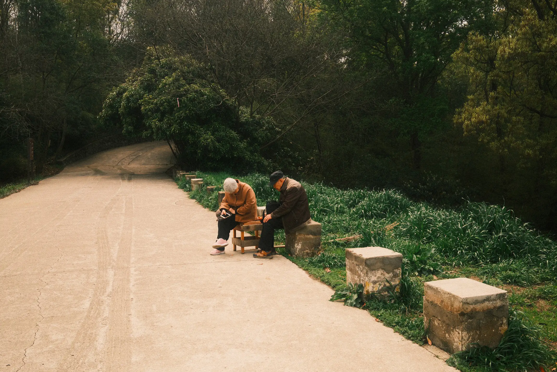 a couple rest by the side of the road leading up the mountain