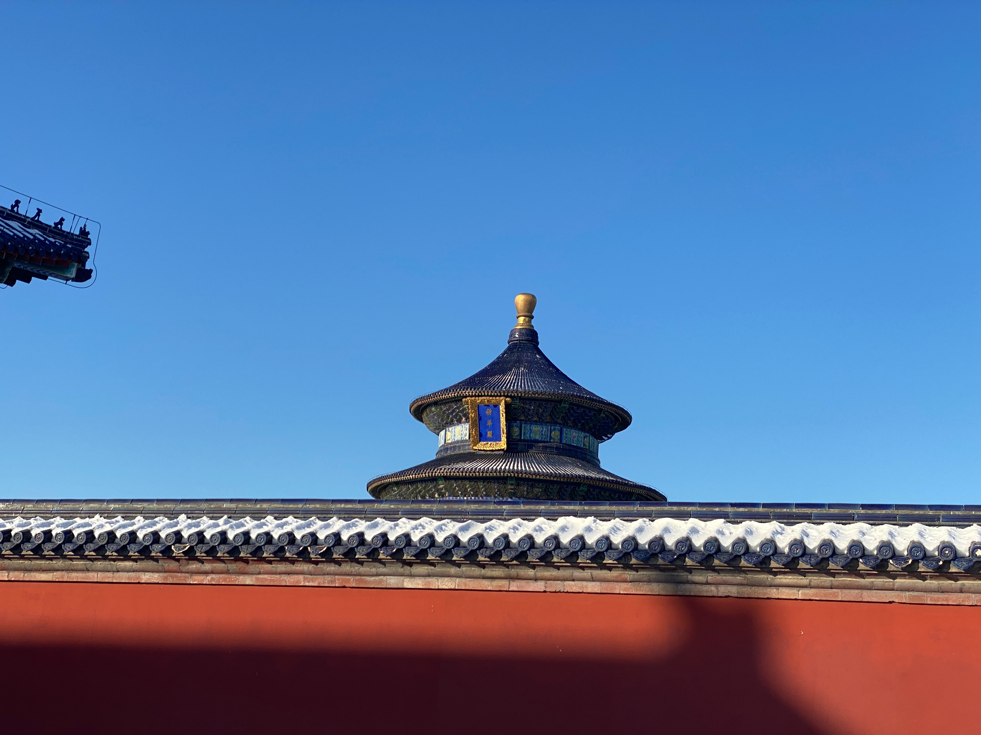 Looking over the wall at the temple behind. This was a popular spot for costume photos, but look up above the mele below and you can find relative stillness.