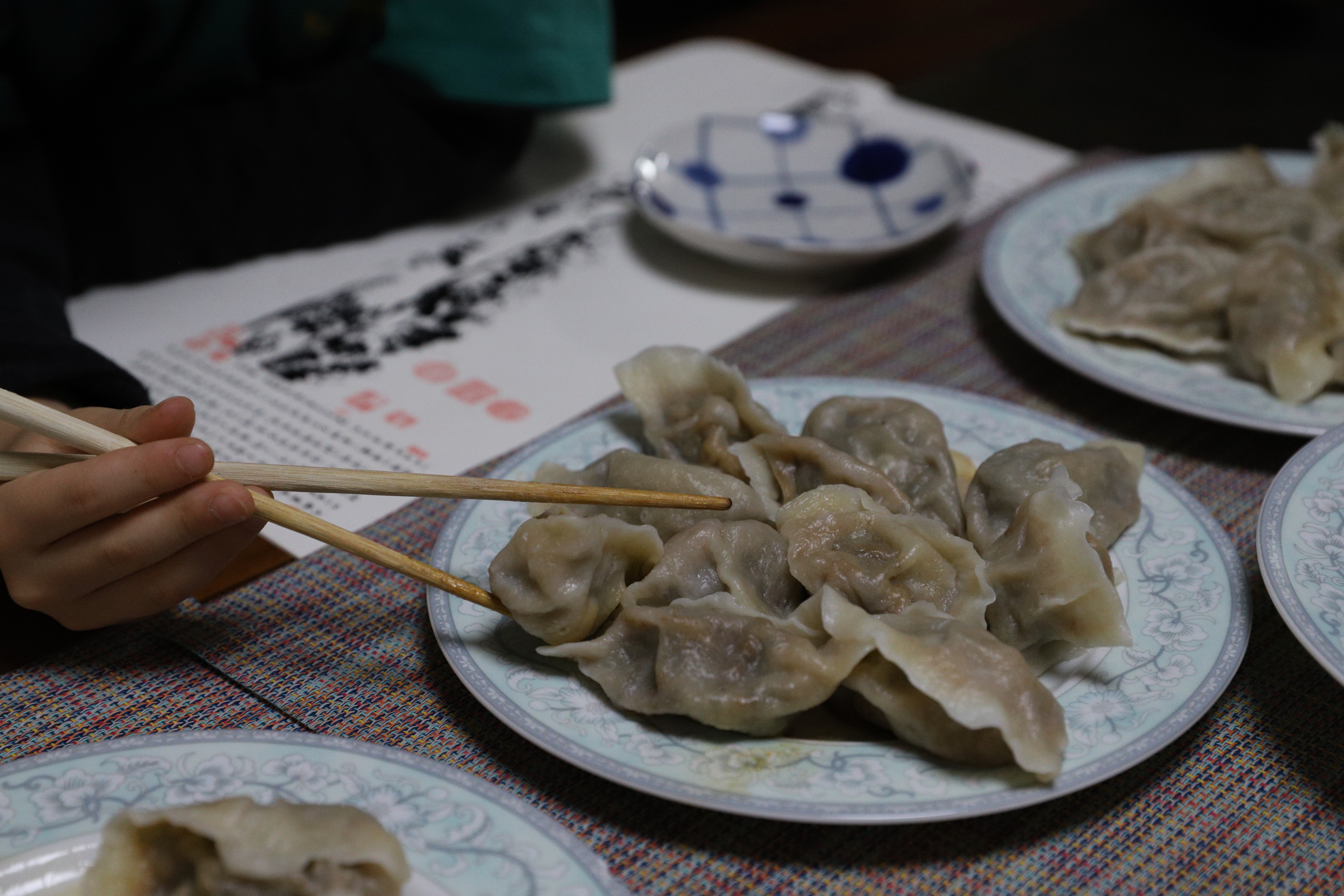 Chopsticks essentials include transfering dumplings from one plate to another.